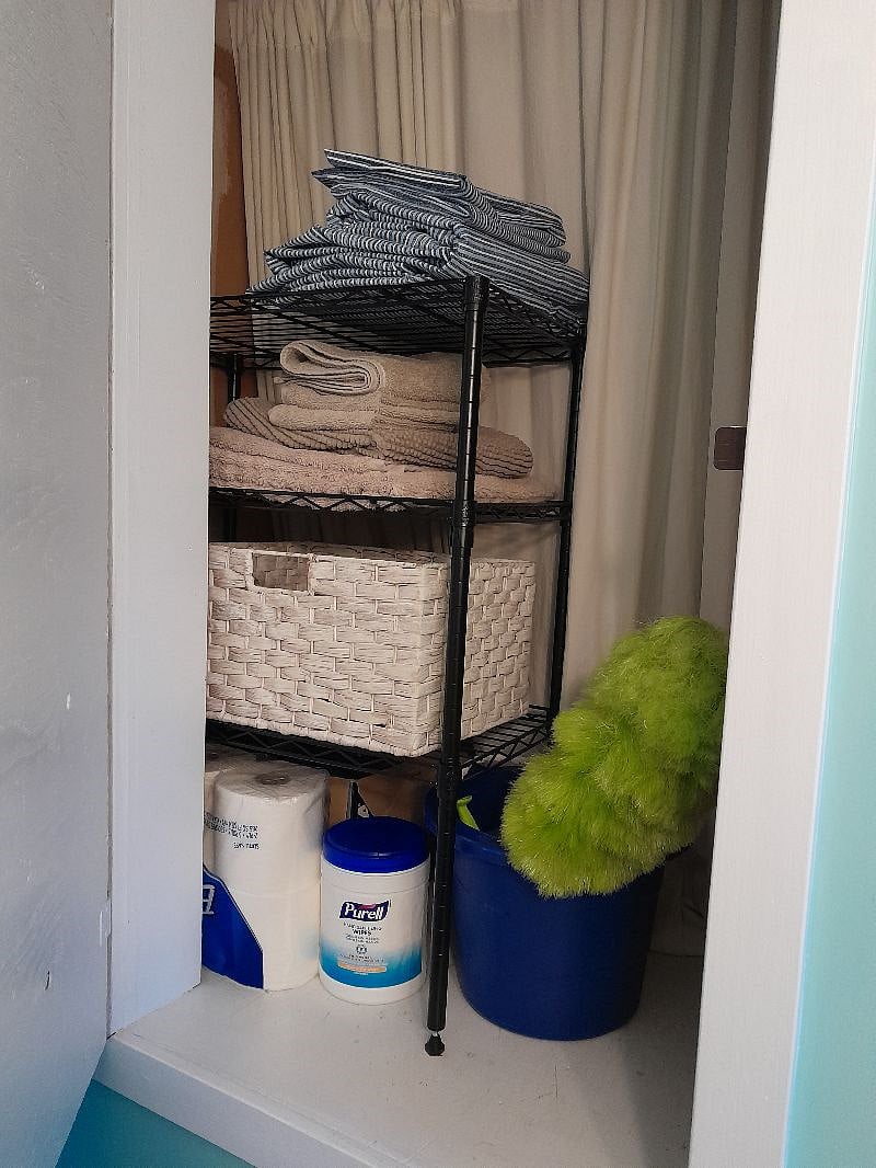 This is a deep closet cabinet which holds linens and towels, cleaning supplies and behind the curtain there is more space for at least two full sized pieces of luggage if needed.