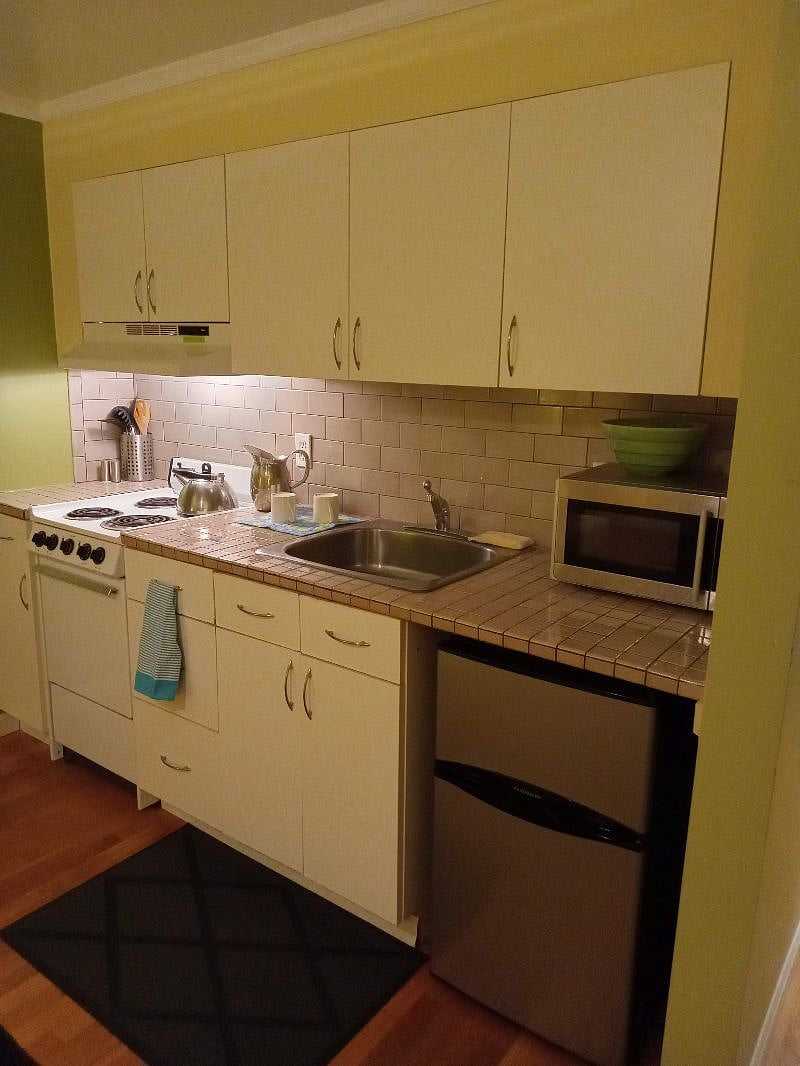 The kitchenette is fully operational. Includes a french press and a drip coffee maker, and a mini fridge with a convenient and roomy separate freezer. There is a brita filtered water pitcher as well. Dish towels and dish soap provided.