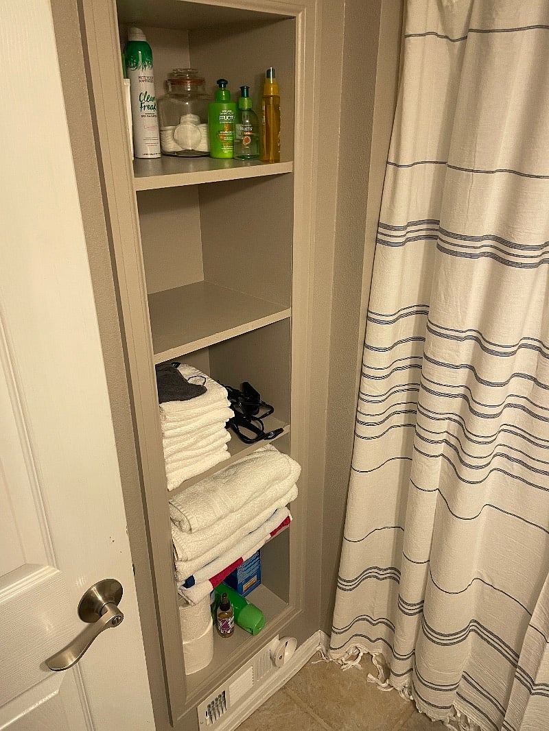 Walls are now white.  Storage cubbies space in bathroom.