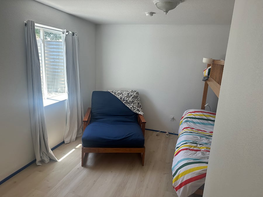 2nd bedroom.  Closet not pictured.
Dark blue chair converts to a twin bed. Bunk is full-size on the bottom twin on the top.  Baseboards to be installed will updated with photos.  New LVP. 