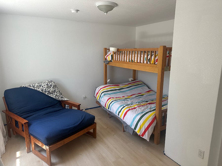 2nd bedroom with closet. Dark blue chair converts to a twin size bed.  Bottom bunk is full size top is twin.  Baseboards to be installed will update with pictures.  New LVP. 