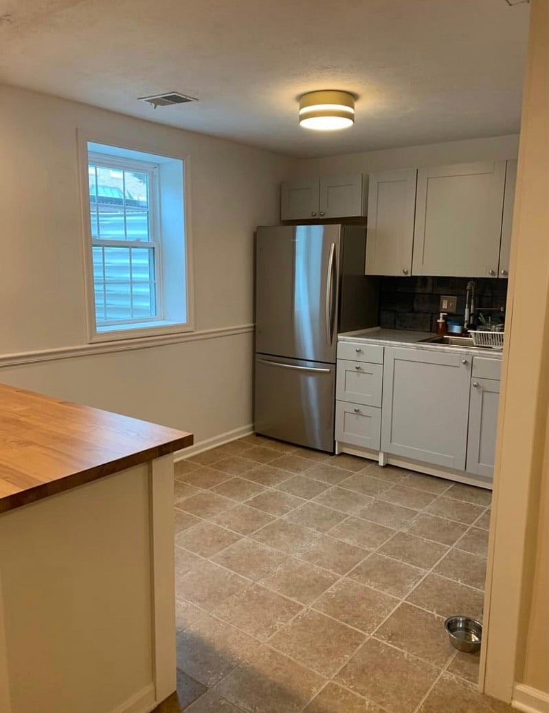 Full-sized refrigerator and professional faucet. Plenty of kitchen storage.