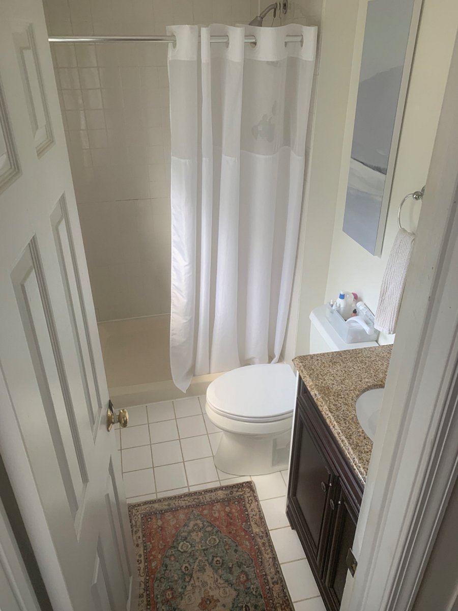 Airy bathroom with premium Speakman showerhead.