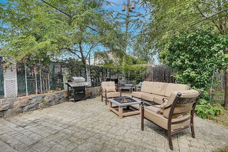 Stamped concrete patio with grill, fire pit and furniture. Fully fenced with new six foot wooden privacy fence. 
