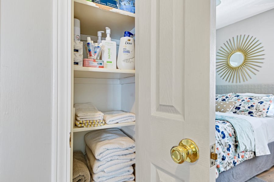 Linen closet stocked with essentials, towels + extra sheets/blankets.
