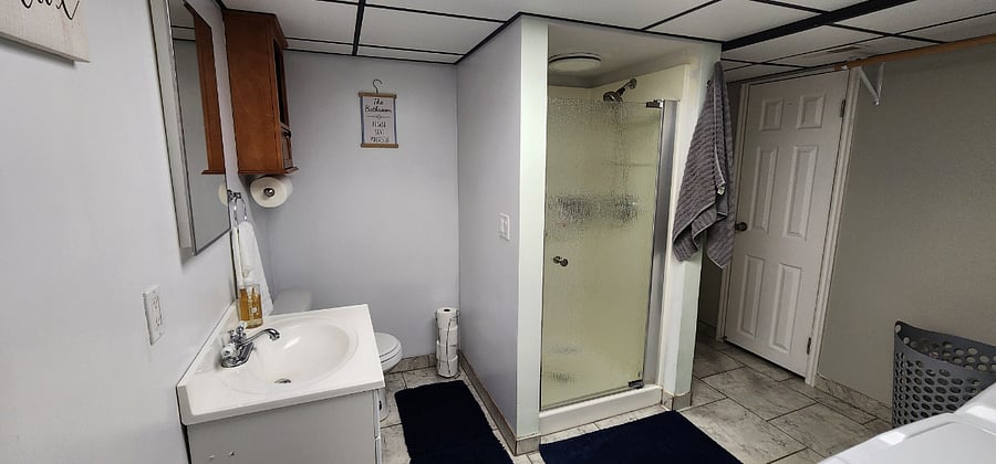 Basement level bathroom with shower.