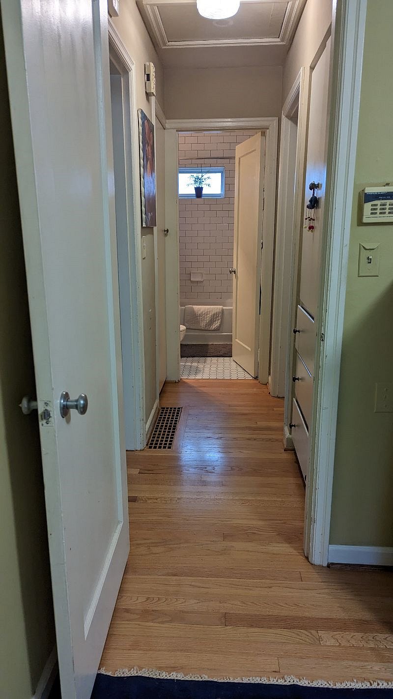 Hallway with built-in's and coat closet /wetsuit closet.