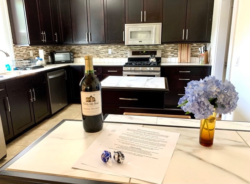 Beautifully updated kitchen with an island, gas range, dishwasher, full size refrigerator, and stocked utilities.