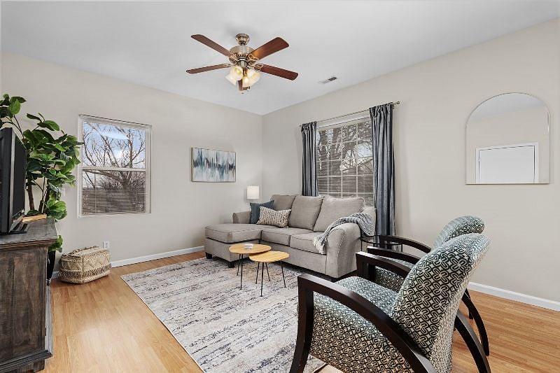 The living room features plenty of seating