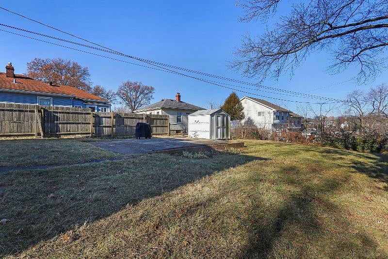 Backyard with patio, grill and shed for storage