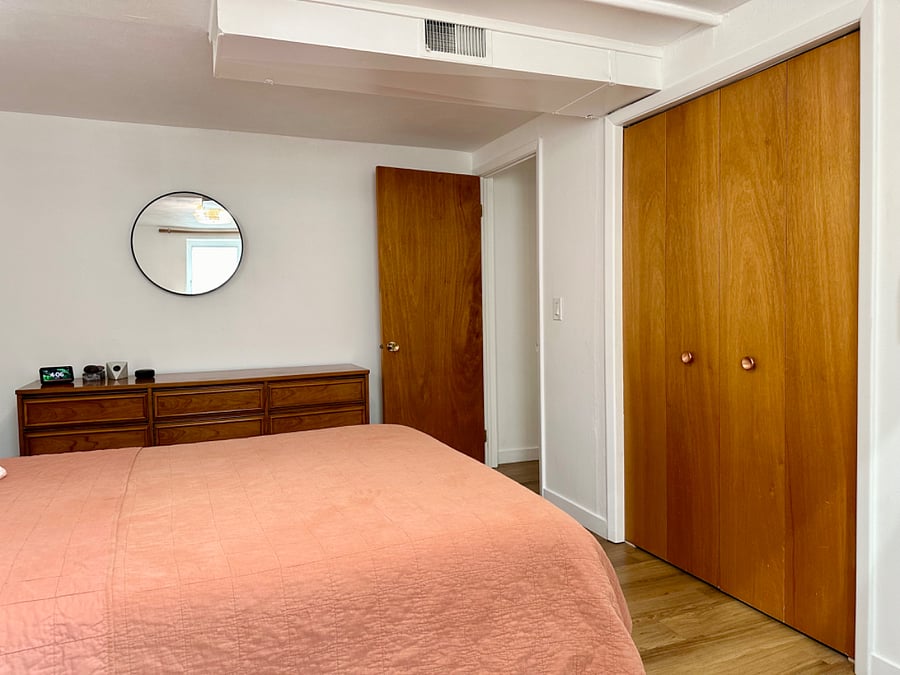 Double door access to closet with cedar wood walls. 