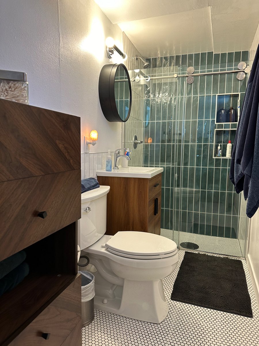 Free-standing cabinet for linens and bathroom essentials. Water efficient toilet and new sink/faucet. 