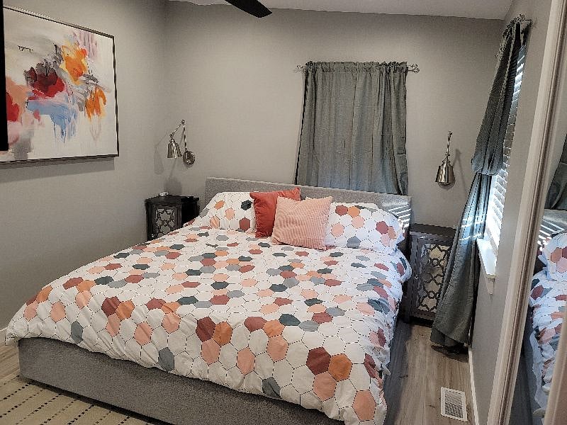 Cozy bedroom with king bed. Chargers are located on each nightstand.