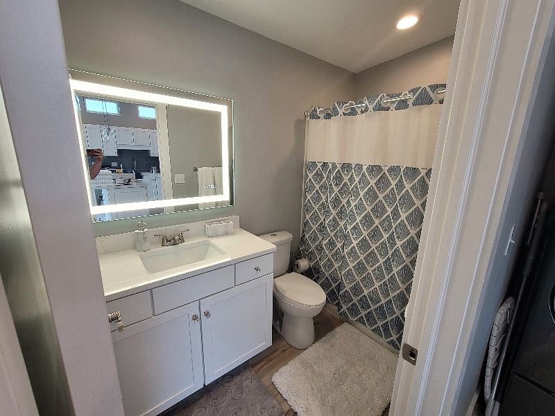 Bathroom with full size tub/shower. Mirror light can be turned on/off, color temperature changed, and has a defogger built in that can be turned on to keep it from fogging up when the shower is running.