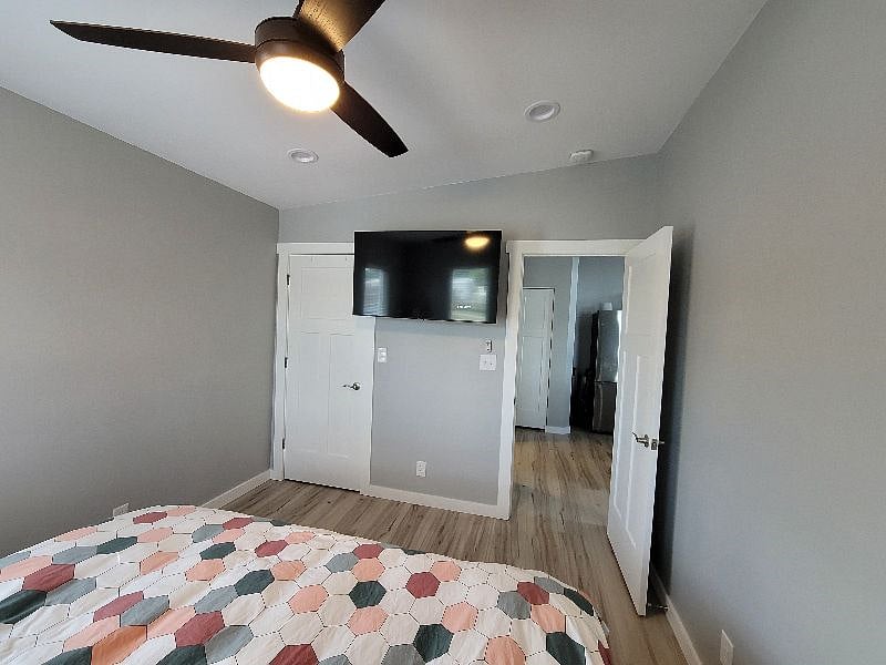 TV in bedroom is 50" and on full motion swivel. A storage ottoman is also now under the TV and stores a second set of bed linens including duvet and duvet cover