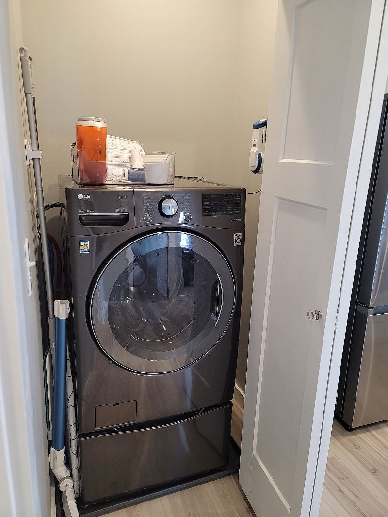 All in one washer/dryer - washes and dries your cloths! We loved the one we got for our house so much we put the same model in the carriage house! Ironing board and iron are also now in this area.