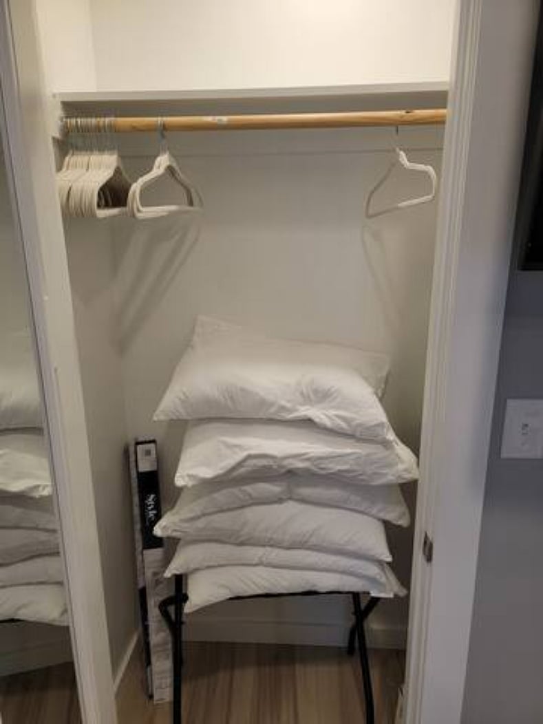 Just part of the closet - there are shelves that fill up the right inside of the closet. Pillows have since been moved to be stored in drawer under bed.