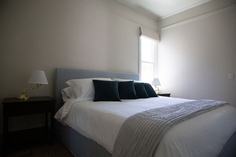 King size bed on main level next to bathroom