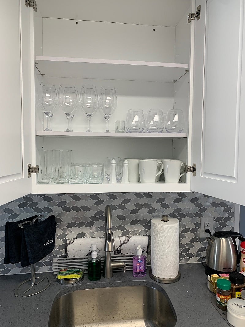 Cups/drinking glasses, mugs, wine glasses, salt and pepper shakers, towels, paper towels, dish soap, dish sponge, hand sanitizer, dish drying rack