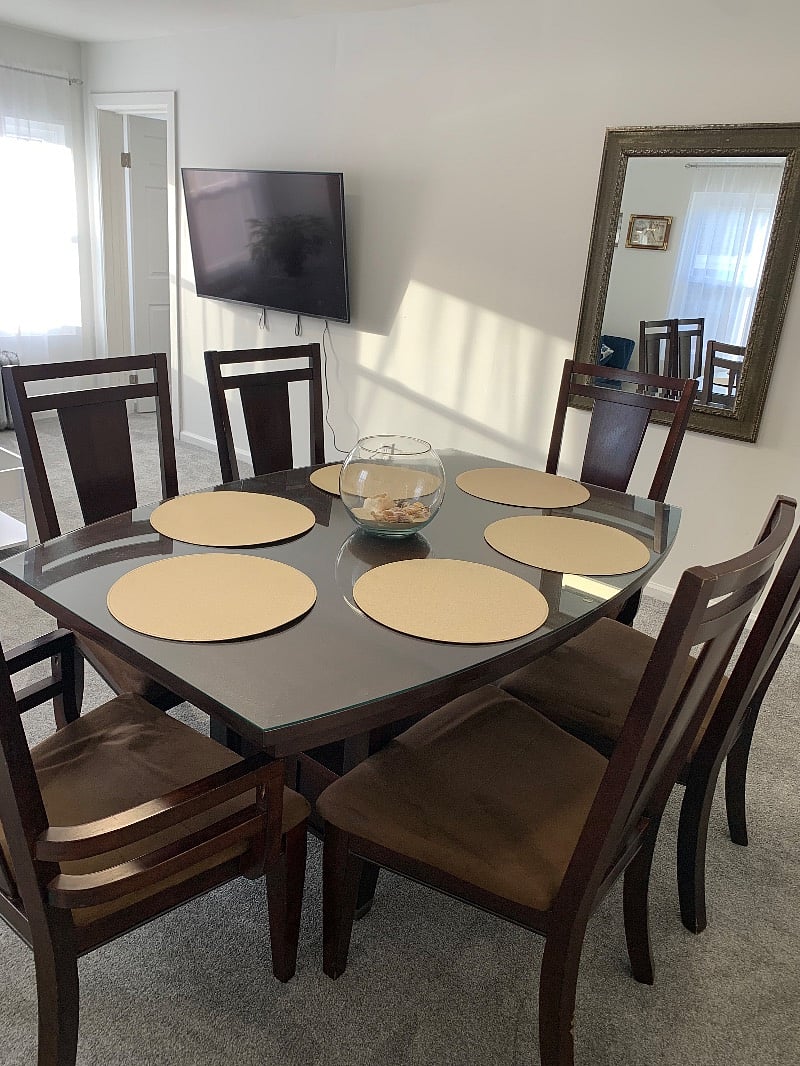 Dining Room with mirror facing the dining table / Living Room with TV across from the couch.