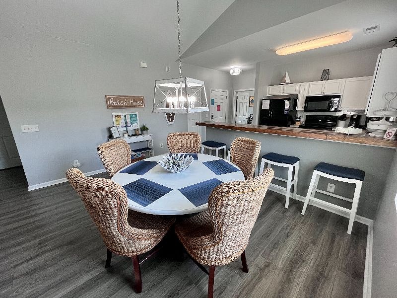 Dining table has seating for six (extra chair not pictured) and four more seats at the breakfast bar.