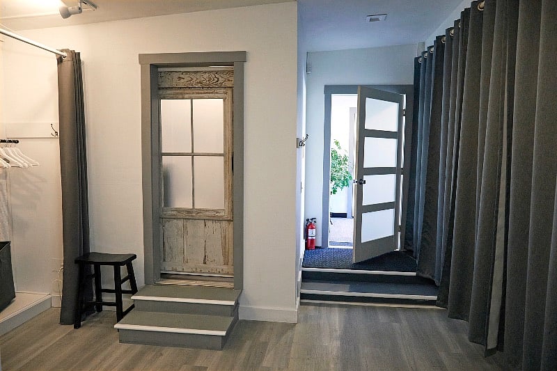 Steps lead up to separate bedroom with sliding "barn" door for privacy.