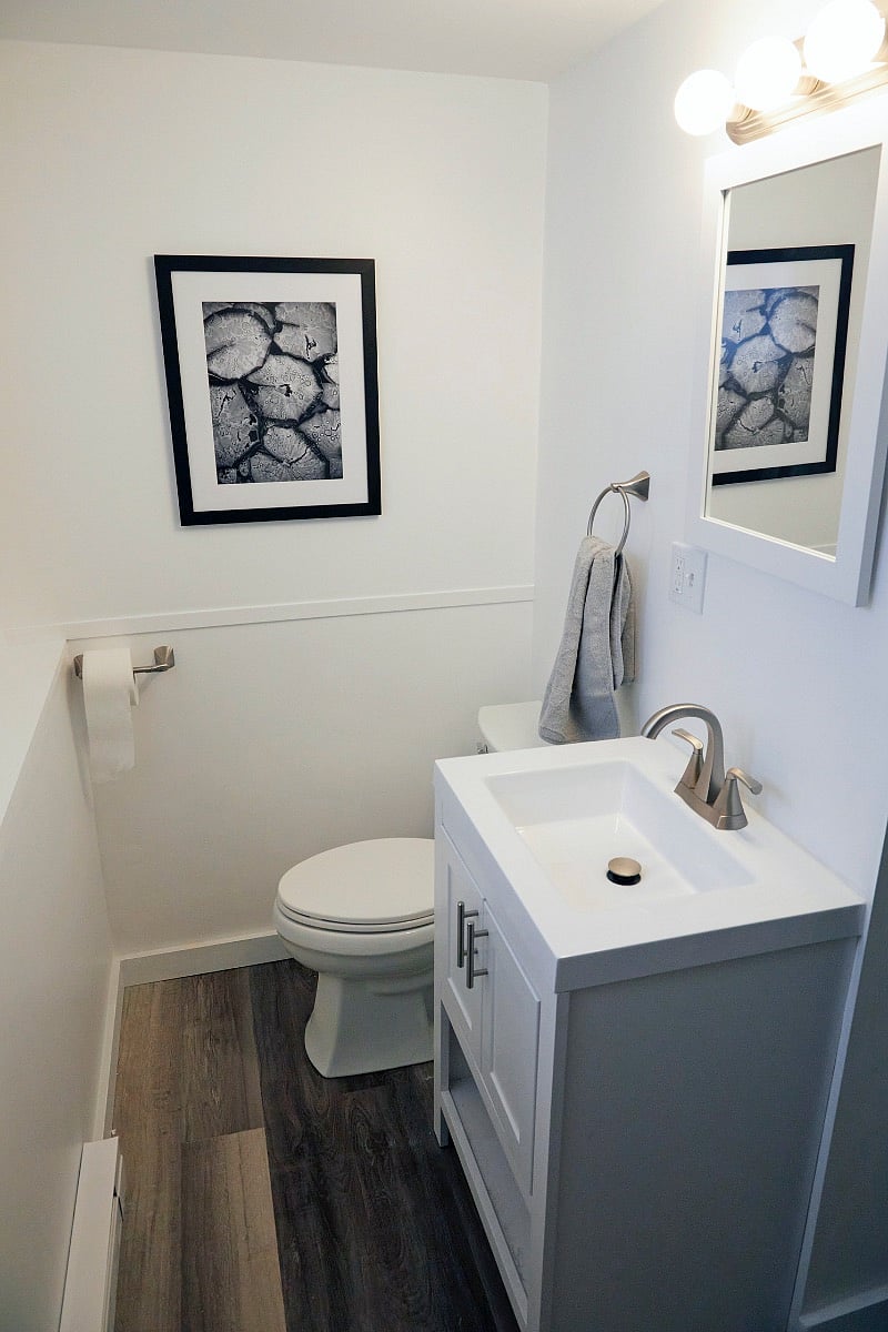 Updated bathroom with dedicated heater, bright lighting, provided linens, and standing shower.