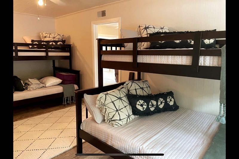 Bunk Room with two full size lower beds and two additional beds on top. Also a 65" large screen tv for gaming or movies