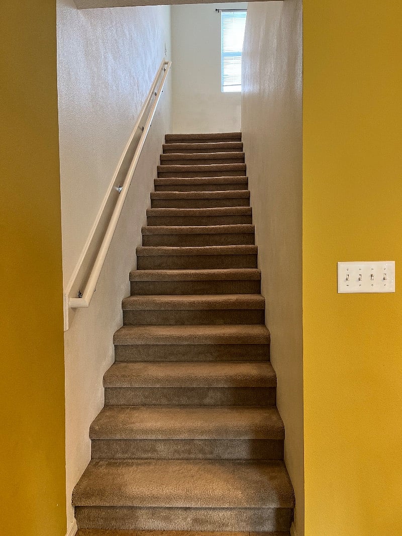 Stairs going up where 2 bedrooms and 2 full bathrooms and full washer and dryer are located 