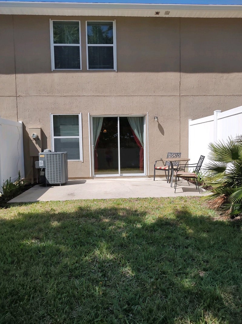 Back patio off living room with slider doors 