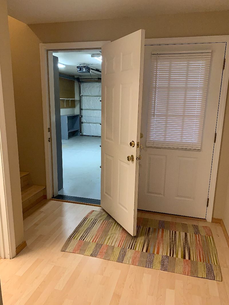 Direct access to garage, front door on right, staircase to upper bedroom on left of garage door