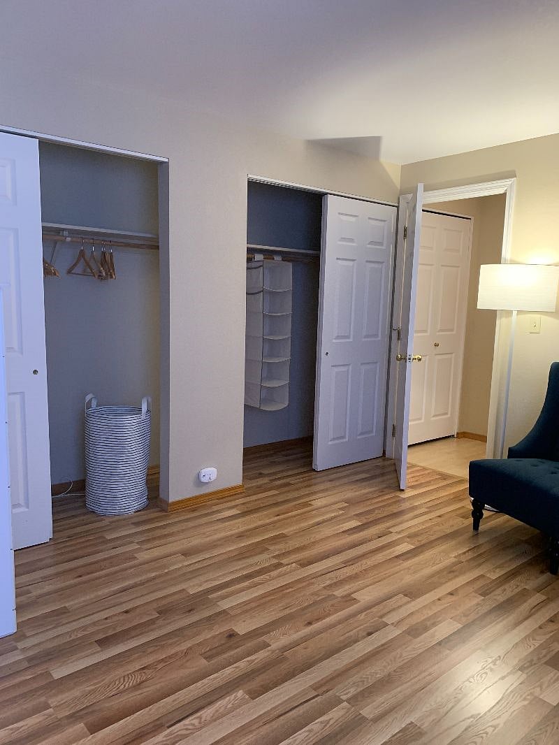 Two hanging closets in upper bedroom, with linen cupboard at top of staircase