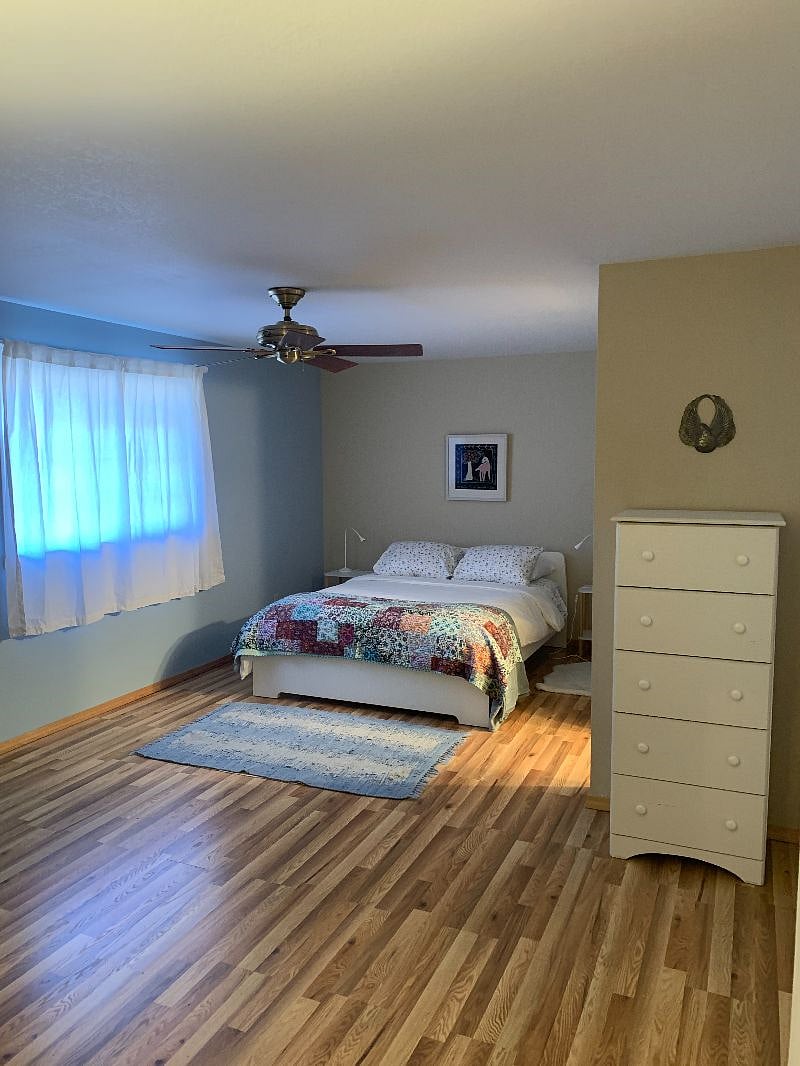 Queen-size bed and chest of drawers in spacious upper bedroom