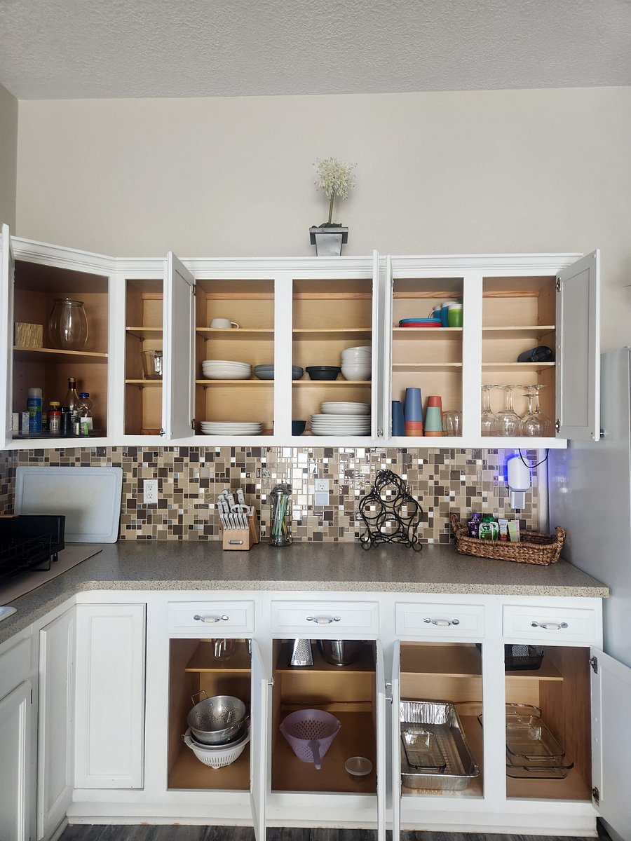 Kitchen Cabinet, dishes cups, plates, cups, wine glasses, and other items