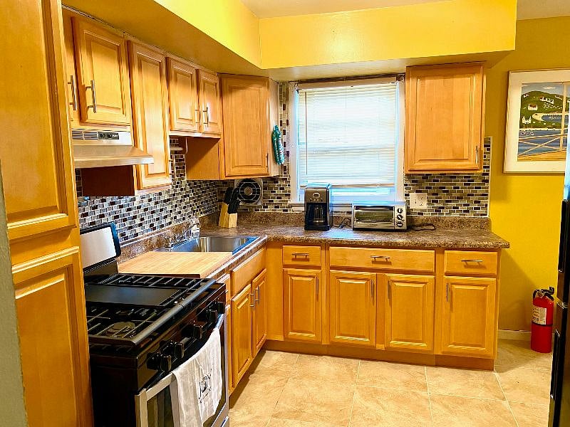 Kitchen has Pots, pans, baking materials, utensils, knives etc