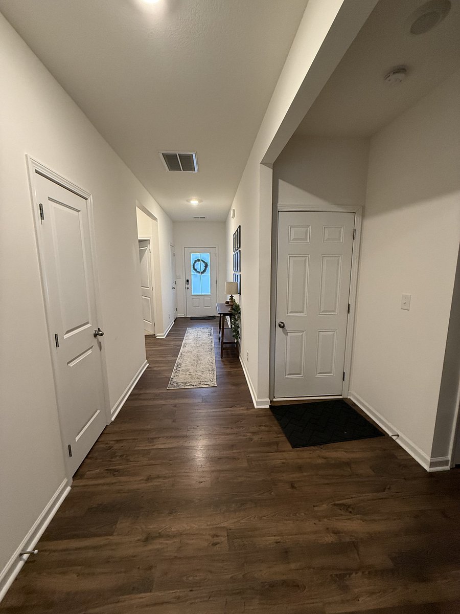 Hallway from kitchen to *mostly private* front door entrance. I typically enter through garage door on the right. Bedrooms & bathroom are just to the left of front door. 