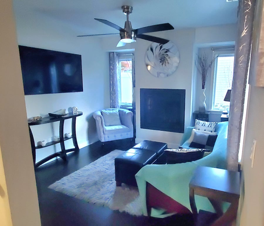 Second view: Quaint, cozy living room with fireplace and large screen TV.