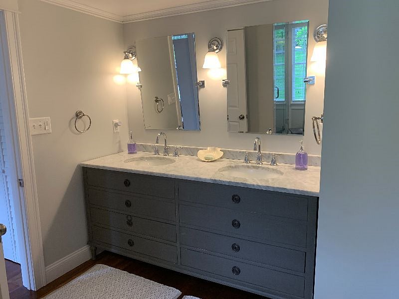 The full bathroom has a double sink and a large walk in shower.