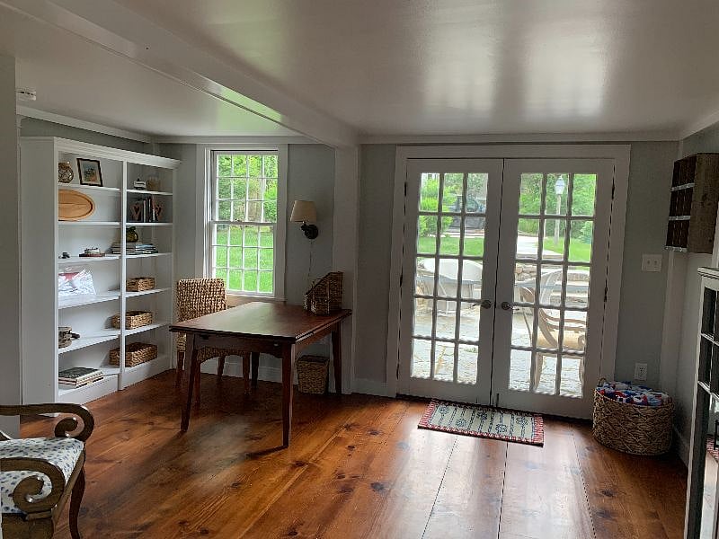 The desk area with two french doors that lead to the outdoor patio.