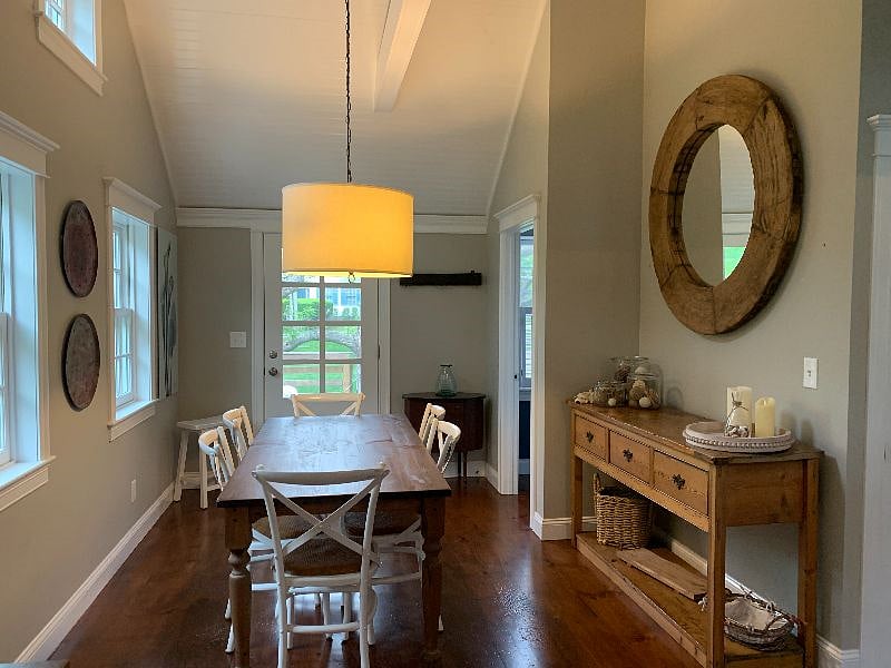 The dining room leads to the front porch with rocking chairs.