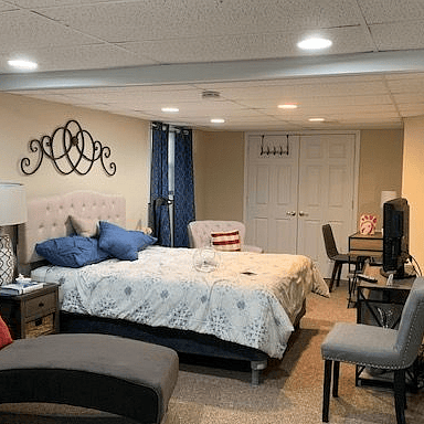 View of bed, closet, seating area and desk, TV