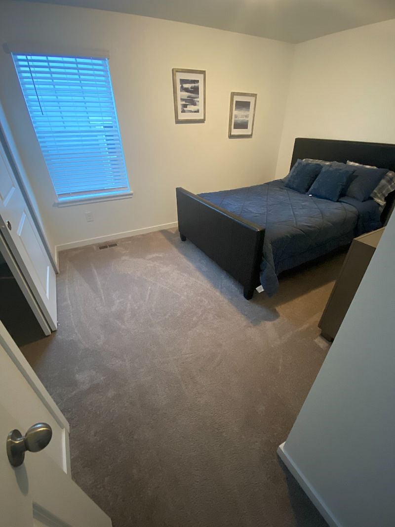 Secondary Bedroom with mirror and dresser