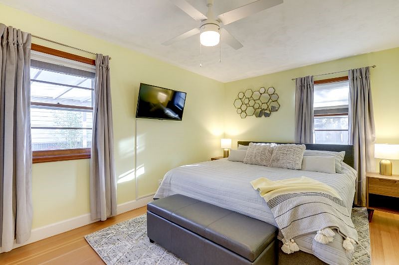 Primary bedroom, with TV, ceiling fan, large closet.