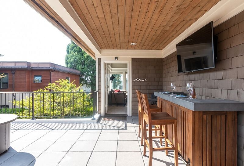 Quiet covered patio with a 70" SmartTV just outside the apartment