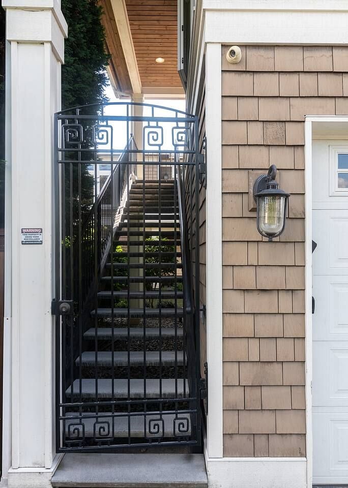Secure private gate and staircase to the apartment above the detached garage