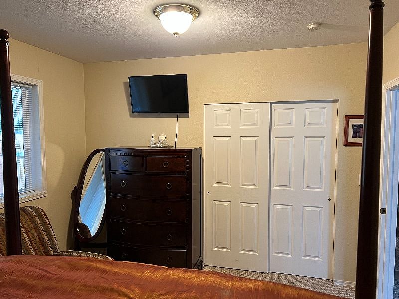 View of tv in main bedroom