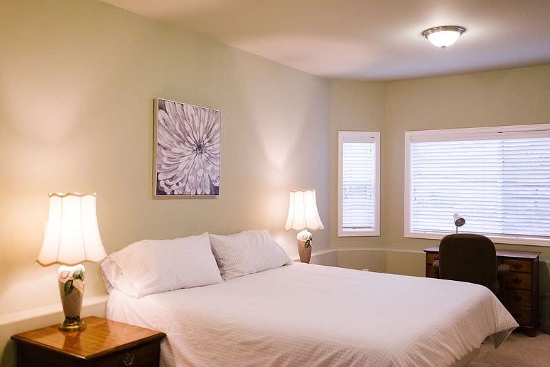 King size bed, two nightstands with lamps and desk/office space combined