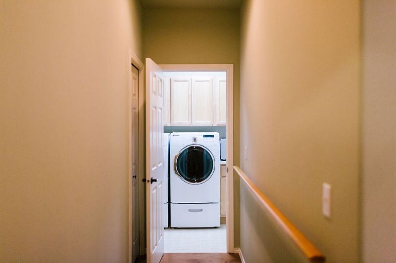 Looking to laundry room through main hallway near bedroom entry