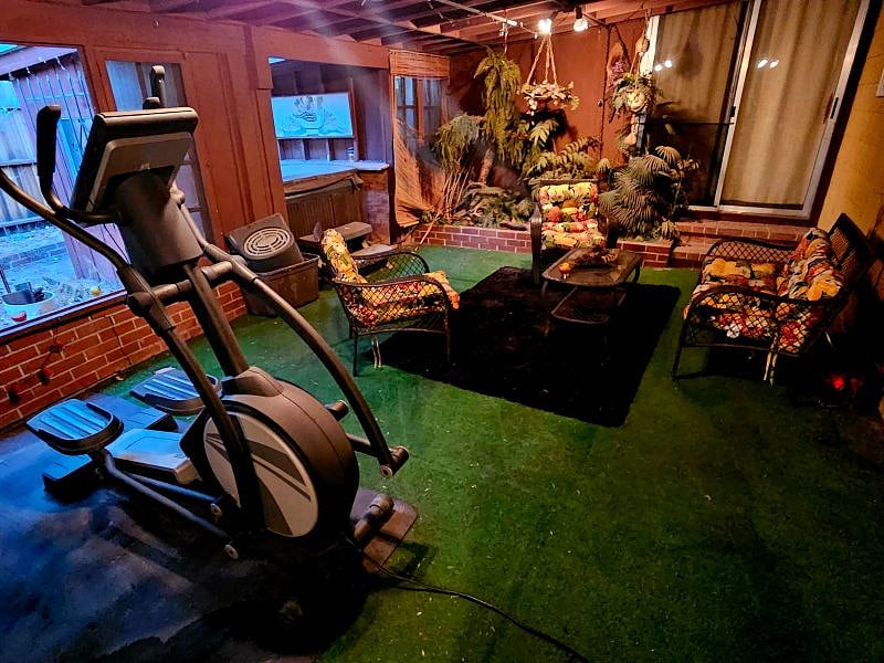 Covered patio with elliptical, tv, seating