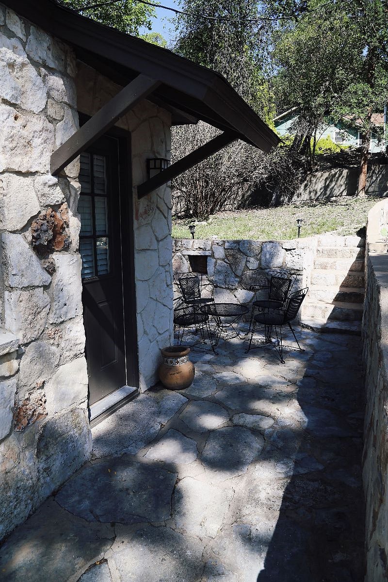 Outdoor area with small table for morning coffee. Up the stairs is a larger table for outdoor dining and a seating area around a fire pit. Gas Grill for cookouts!
